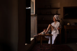  A woman enjoying must-have bathrobe features.